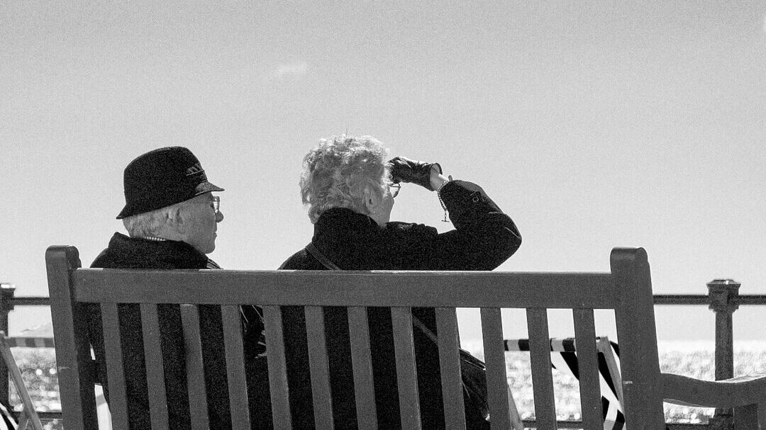 two older people on a bench