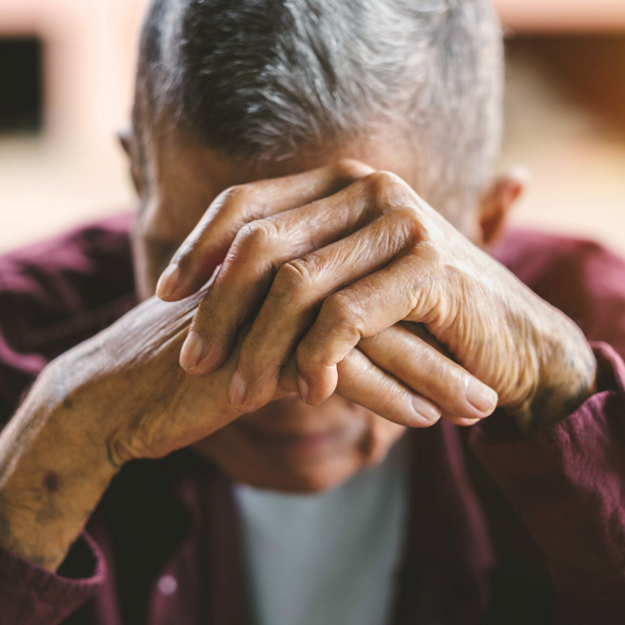 older man with head in his hands