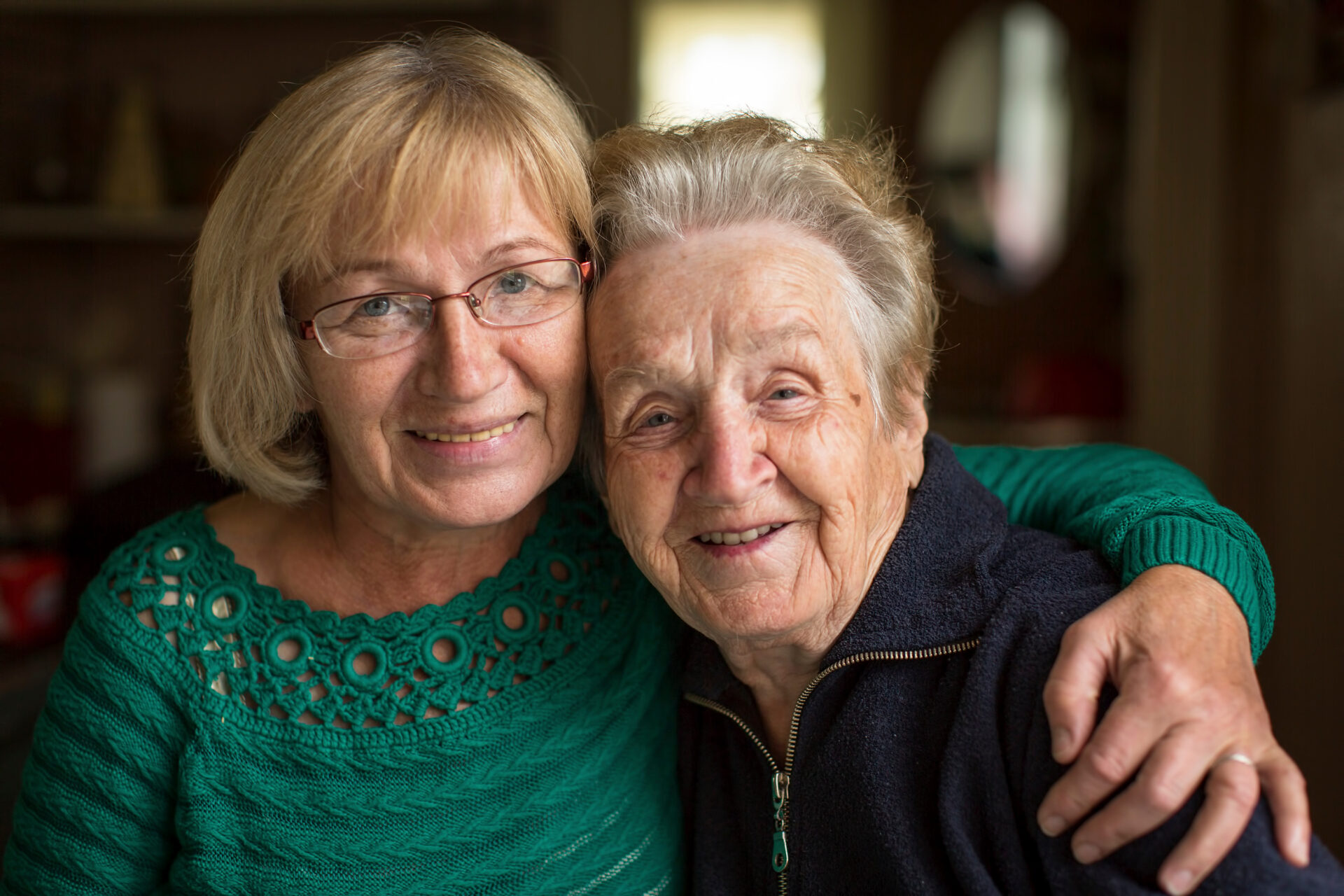 Younger and older woman hugging